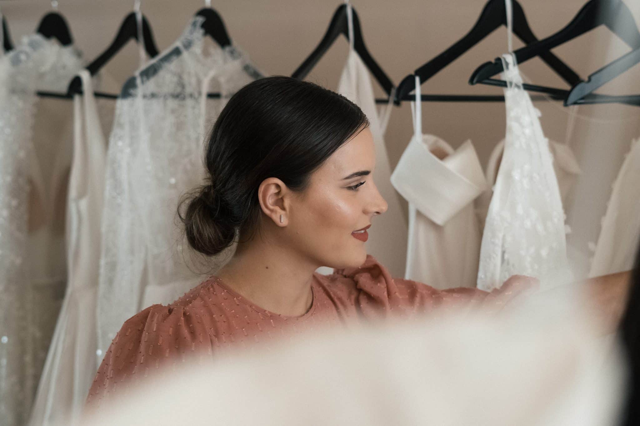 Mujer eligiendo vestidos de novia